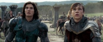 Movie still from “The Chronicles of Narnia: Prince Caspian” (2008), directed by Andrew Adamson – Two people in medieval costumes standing in a field; Medium shot, Low angle