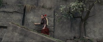 Movie still from “The Chronicles of Narnia: Prince Caspian” (2008), directed by Andrew Adamson – A woman with a bow and arrow walking up a ramp; Wide shot, High angle