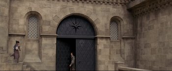 Movie still from “The Chronicles of Narnia: Prince Caspian” (2008), directed by Andrew Adamson – A man walking in front of a building with a star on it; Extreme Wide shot, High angle