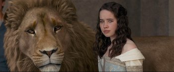 Movie still from “The Chronicles of Narnia: Prince Caspian” (2008), directed by Andrew Adamson – A woman standing in front of a large lion; Close Up shot, Low angle