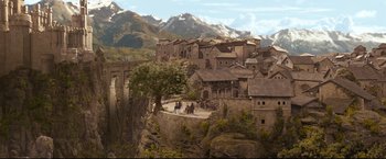 Movie still from “The Chronicles of Narnia: Prince Caspian” (2008), directed by Andrew Adamson – An old town with a bridge and mountains in the background; Extreme Wide shot, High angle