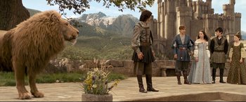 Movie still from “The Chronicles of Narnia: Prince Caspian” (2008), directed by Andrew Adamson – A man dressed in medieval garb standing on a stone platform; Wide shot, Low angle