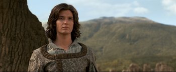 Movie still from “The Chronicles of Narnia: Prince Caspian” (2008), directed by Andrew Adamson – A man with long brown hair wearing a brown and white shirt; Close Up shot, Low angle