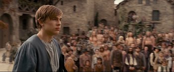 Movie still from “The Chronicles of Narnia: Prince Caspian” (2008), directed by Andrew Adamson – A man standing in front of a group of people; Medium shot, Over the shoulder angle