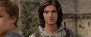 Movie still from “The Chronicles of Narnia: Prince Caspian” (2008), directed by Andrew Adamson – A young man with long hair and a brown shirt; Close Up shot, Over the shoulder angle