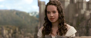 Movie still from “The Chronicles of Narnia: Prince Caspian” (2008), directed by Andrew Adamson – A young woman with long brown curly hair; Close Up shot, Over the shoulder angle