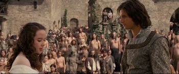 Movie still from “The Chronicles of Narnia: Prince Caspian” (2008), directed by Andrew Adamson – A large group of people standing in front of a building; Medium shot, Over the shoulder angle