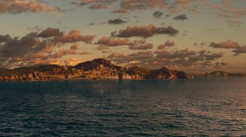 Movie still from “The Chronicles of Narnia: The Voyage of the Dawn Treader” (2010), directed by Michael Apted – A large body of water near a mountain range under a cloudy sky; Extreme Wide shot, High angle