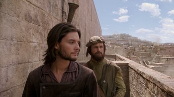 Movie still from “The Chronicles of Narnia: The Voyage of the Dawn Treader” (2010), directed by Michael Apted – Two men are standing next to each other on a wall; Medium shot, Over the shoulder angle
