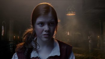 Movie still from “The Chronicles of Narnia: The Voyage of the Dawn Treader” (2010), directed by Michael Apted – A young girl in a dark room looking at the camera; Close Up shot, Over the shoulder angle