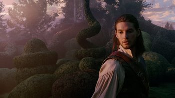 Movie still from “The Chronicles of Narnia: The Voyage of the Dawn Treader” (2010), directed by Michael Apted – A man standing in front of bushes in a forest; Medium shot, Low angle