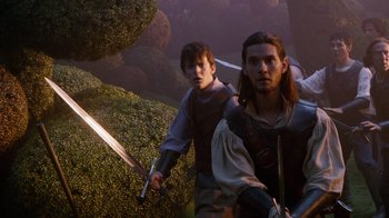Movie still from “The Chronicles of Narnia: The Voyage of the Dawn Treader” (2010), directed by Michael Apted – Two young men in medieval garb are holding swords; Medium shot, Low angle