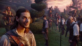 Movie still from “The Chronicles of Narnia: The Voyage of the Dawn Treader” (2010), directed by Michael Apted – A group of people standing in front of a statue of a man; Medium shot, Over the shoulder angle