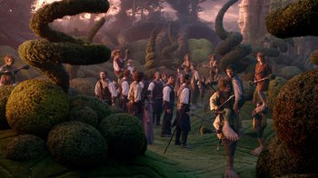 Movie still from “The Chronicles of Narnia: The Voyage of the Dawn Treader” (2010), directed by Michael Apted – A group of people standing in the grass near a forest; Wide shot, High angle