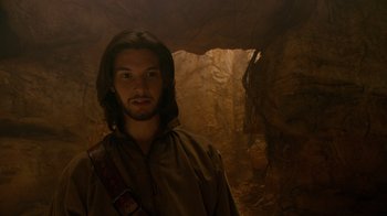 Movie still from “The Chronicles of Narnia: The Voyage of the Dawn Treader” (2010), directed by Michael Apted – A man standing in front of a rock cave; Close Up shot, Low angle
