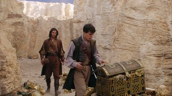 Movie still from “The Chronicles of Narnia: The Voyage of the Dawn Treader” (2010), directed by Michael Apted – Two men in medieval garb walking past a chest; Medium shot, High angle
