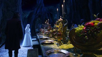 Movie still from “The Chronicles of Narnia: The Voyage of the Dawn Treader” (2010), directed by Michael Apted – A woman in a white dress standing in front of a long table; Wide shot, Over the shoulder angle