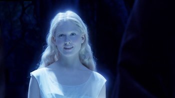 Movie still from “The Chronicles of Narnia: The Voyage of the Dawn Treader” (2010), directed by Michael Apted – A young blonde woman in a white dress with blue lighting; Close Up shot, Over the shoulder angle