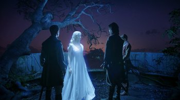 Movie still from “The Chronicles of Narnia: The Voyage of the Dawn Treader” (2010), directed by Michael Apted – A group of people standing next to each other in front of a tree at night; Wide shot, Over the shoulder angle