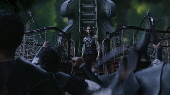 Movie still from “The Chronicles of Narnia: The Voyage of the Dawn Treader” (2010), directed by Michael Apted – A man standing in front of a crowd of people on stairs; Wide shot, Over the shoulder angle