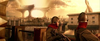 Movie still from “The Chronicles of Riddick” (2004), directed by David Twohy – A man with a helmet on sitting on a chair; Wide shot, Low angle