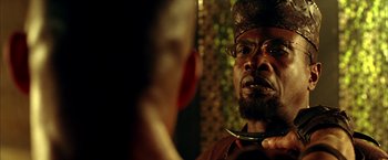 Movie still from “The Chronicles of Riddick” (2004), directed by David Twohy – A man looking at himself in the mirror; Close Up shot, Over the shoulder angle