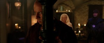 Movie still from “The Chronicles of Riddick” (2004), directed by David Twohy – A man and a woman standing next to each other in a room; Close Up shot, Over the shoulder angle