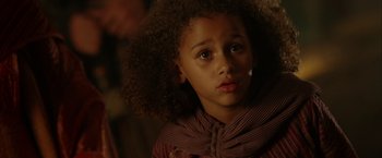 Movie still from “The Chronicles of Riddick” (2004), directed by David Twohy – A little girl is looking into the camera; Close Up shot, Over the shoulder angle