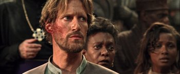 Movie still from “The Chronicles of Riddick” (2004), directed by David Twohy – A man and a woman standing next to each other; Close Up shot, Over the shoulder angle