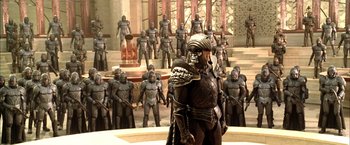 Movie still from “The Chronicles of Riddick” (2004), directed by David Twohy – A lot of people that are dressed up in armor; Wide shot, High angle