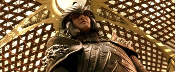 Movie still from “The Chronicles of Riddick” (2004), directed by David Twohy – A person wearing armor and a helmet; Close Up shot, Low angle