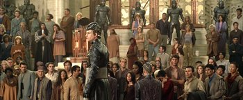 Movie still from “The Chronicles of Riddick” (2004), directed by David Twohy – A crowd of people standing around a building; Wide shot, High angle