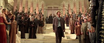 Movie still from “The Chronicles of Riddick” (2004), directed by David Twohy – A group of people standing in front of a building; Wide shot, Low angle