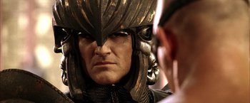 Movie still from “The Chronicles of Riddick” (2004), directed by David Twohy – A person wearing a helmet; Close Up shot, Over the shoulder angle