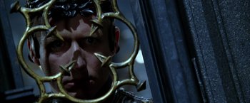 Movie still from “The Chronicles of Riddick” (2004), directed by David Twohy – A man is looking at himself in a mirror; Close Up shot, Over the shoulder angle