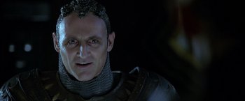 Movie still from “The Chronicles of Riddick” (2004), directed by David Twohy – A person wearing a suit of armor; Close Up shot, Low angle