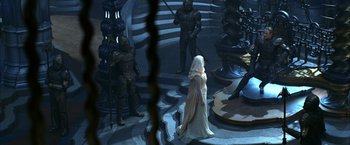 Movie still from “The Chronicles of Riddick” (2004), directed by David Twohy – A group of people standing in a room with statues; Wide shot, High angle