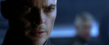 Movie still from “The Chronicles of Riddick” (2004), directed by David Twohy – A man's face in a dark room; Close Up shot, Over the shoulder angle