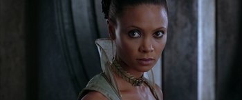 Movie still from “The Chronicles of Riddick” (2004), directed by David Twohy – A person wearing a necklace; Close Up shot, High angle