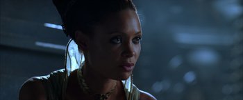 Movie still from “The Chronicles of Riddick” (2004), directed by David Twohy – A person wearing a necklace; Close Up shot, Over the shoulder angle