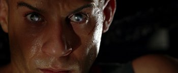 Movie still from “The Chronicles of Riddick” (2004), directed by David Twohy – A man's face with water droplets on it; Extreme Close Up shot, Low angle