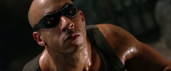 Movie still from “The Chronicles of Riddick” (2004), directed by David Twohy – A man wearing goggles; Close Up shot, Low angle