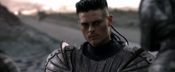 Movie still from “The Chronicles of Riddick” (2004), directed by David Twohy – A person wearing a costume; Close Up shot, Over the shoulder angle