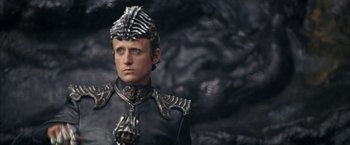 Movie still from “The Chronicles of Riddick” (2004), directed by David Twohy – A man wearing a helmet and a black jacket; Close Up shot, High angle