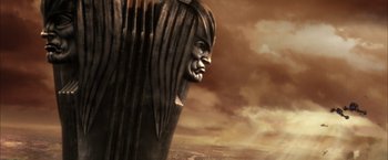 Movie still from “The Chronicles of Riddick” (2004), directed by David Twohy – A large statue of a man with a long hair; Wide shot, Low angle