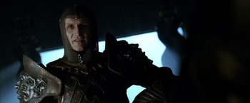 Movie still from “The Chronicles of Riddick” (2004), directed by David Twohy – A person wearing a helmet; Close Up shot, Low angle