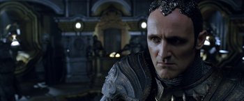 Movie still from “The Chronicles of Riddick” (2004), directed by David Twohy – A person wearing a costume; Close Up shot, Over the shoulder angle