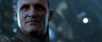 Movie still from “The Chronicles of Riddick” (2004), directed by David Twohy – A person wearing a chain mail head piece; Close Up shot, Low angle