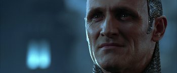 Movie still from “The Chronicles of Riddick” (2004), directed by David Twohy – A man's face in a dark room; Close Up shot, Low angle
