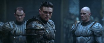 Movie still from “The Chronicles of Riddick” (2004), directed by David Twohy – A person wearing armor; Close Up shot, Over the shoulder angle